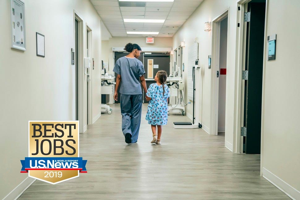 Nurse and child in hospital corridor