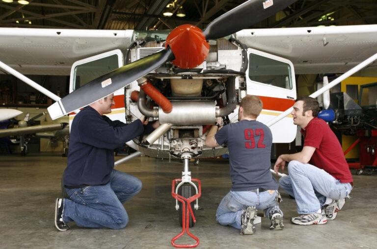 Two people working on a small airplane