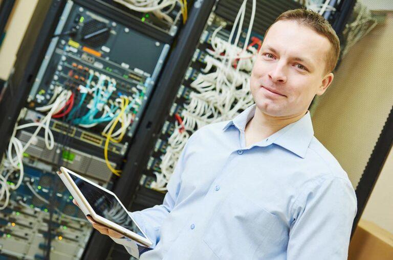 Man in front of computer servers