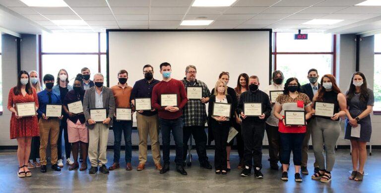group of people holding certificates