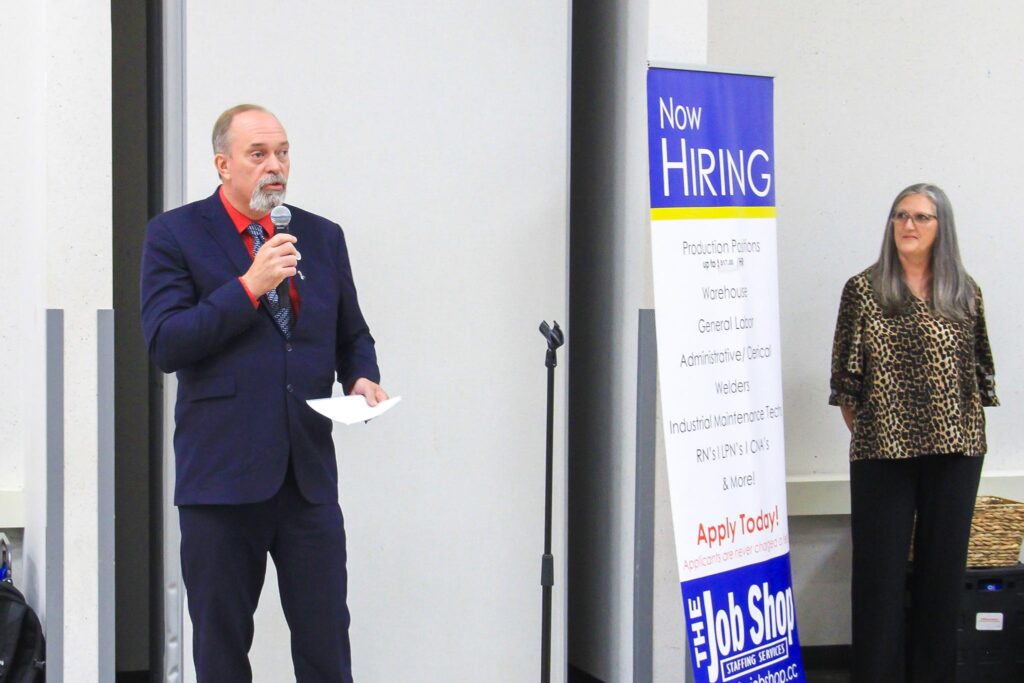 Man and woman addressing audience